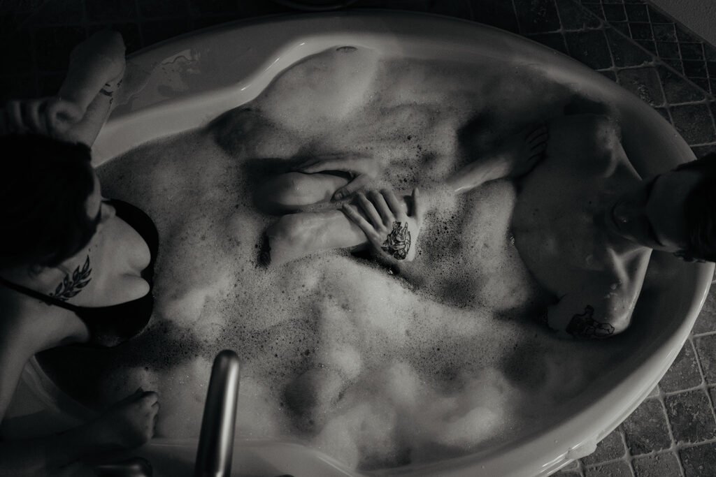 Couple sitting in a jacuzzi taking a bath together before their elopement on the Oregon sand dunes