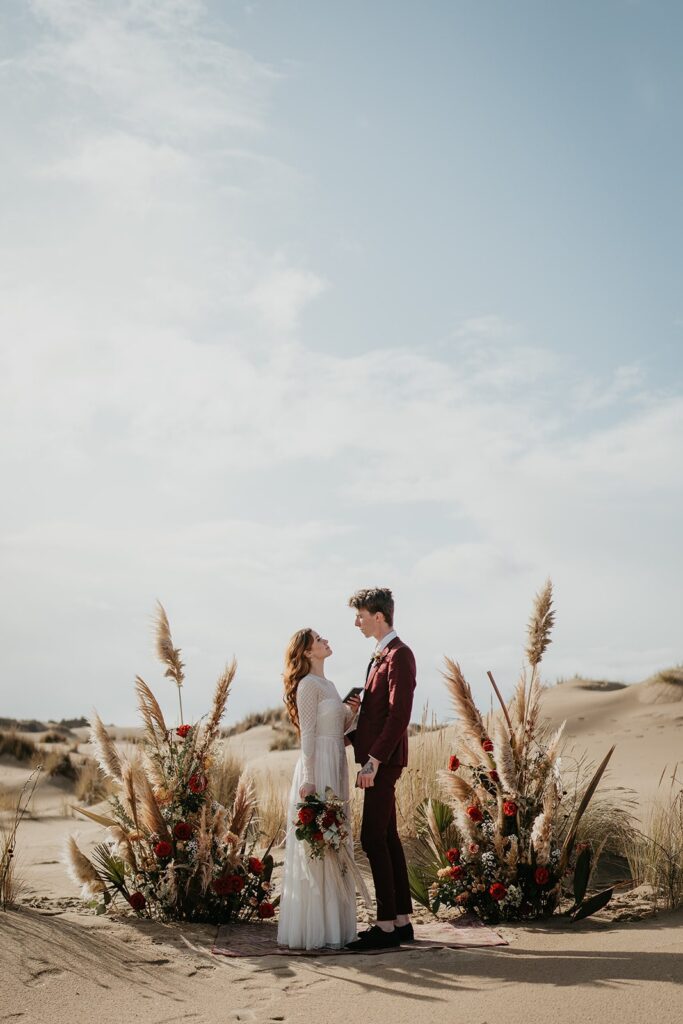 Bride and groom exchange handwritten vows during their Oregon sand dunes elopement ceremony