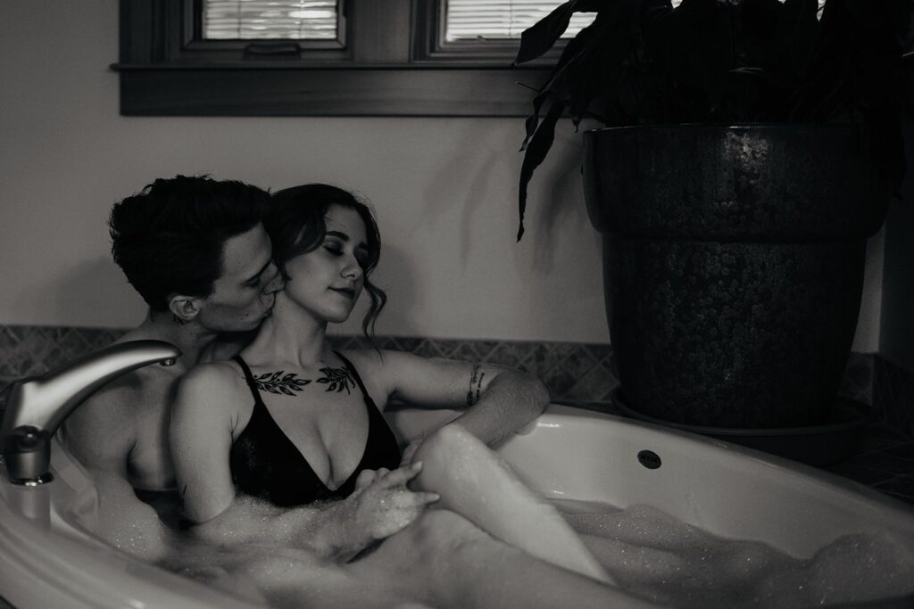 Couple sitting in a jacuzzi taking a bath together before their elopement on the Oregon sand dunes