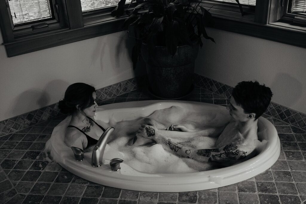 Couple sitting in a jacuzzi before their Oregon sand dunes elopement