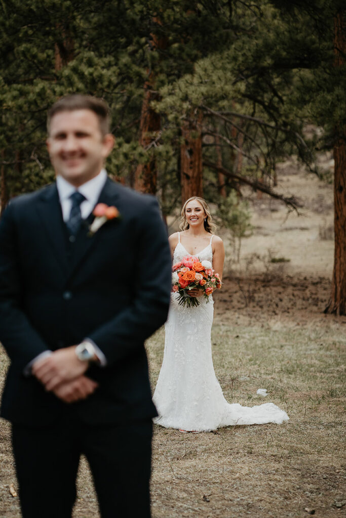 The groom with the bride behind him, right before he turns around for first looks. 