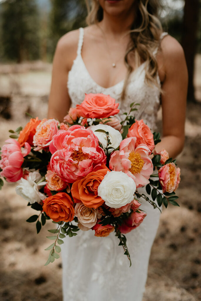 A close up of the bride's red, pink, and white rose bouquet. 