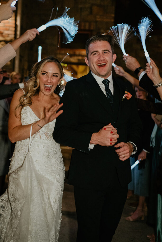 The bride and groom receiving a glow-stick exit. 