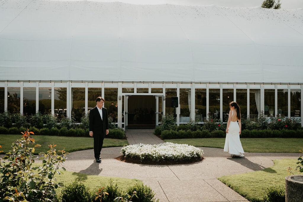 Judith and Joshua walking around a grassy courtyard. 