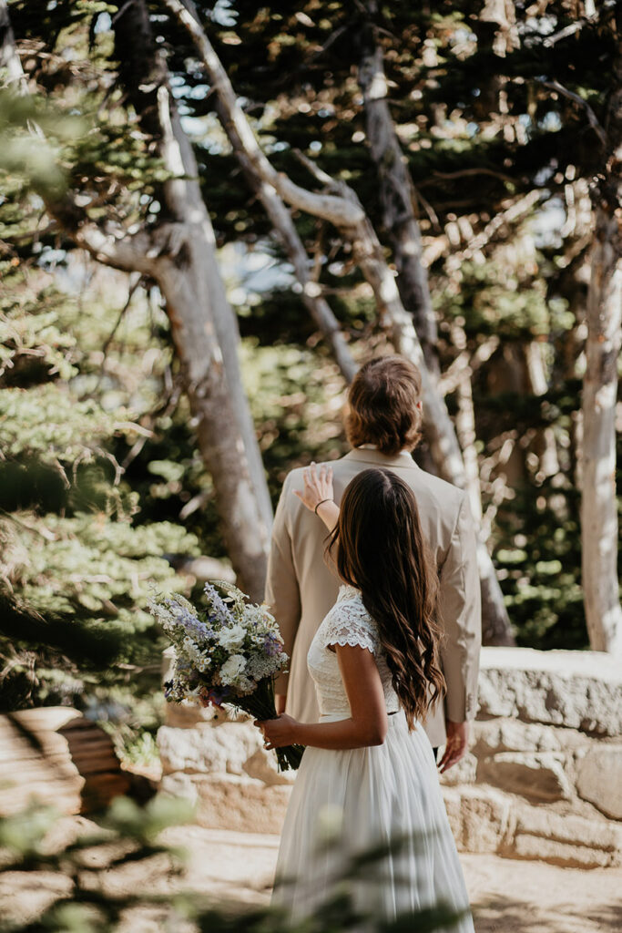 The bride tapping on her husband's shoulder during Mt Rainier. 