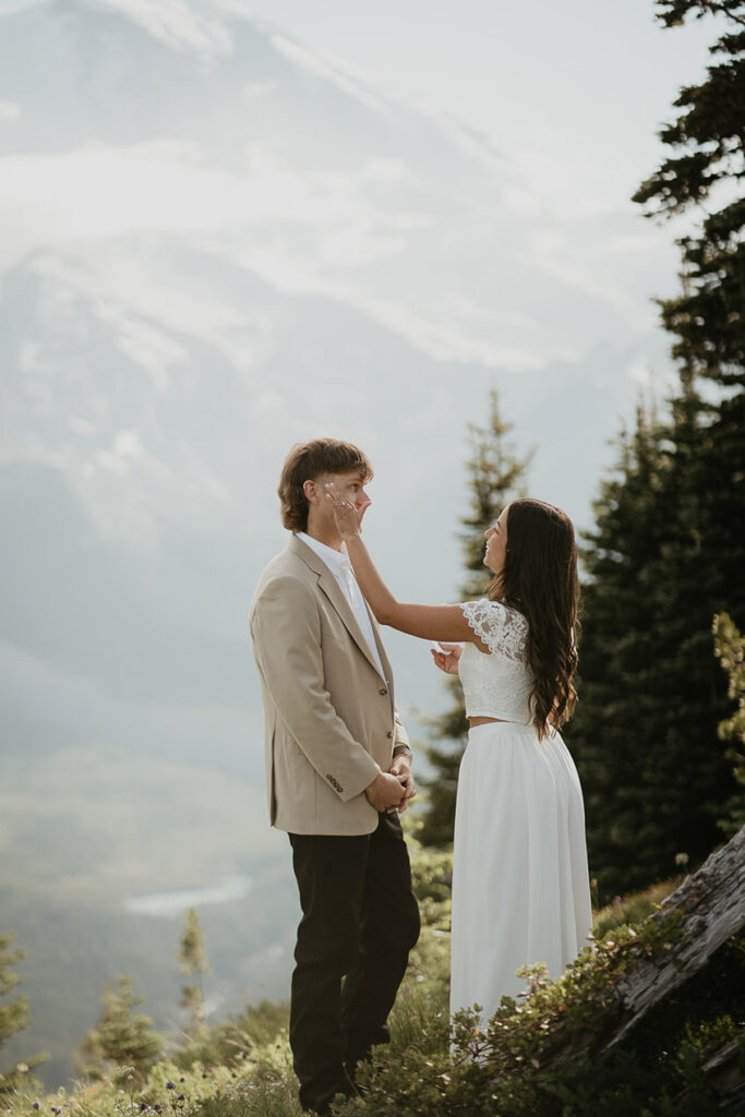 The bride wiping a tear from her husband's eye after she read her vows to him. 