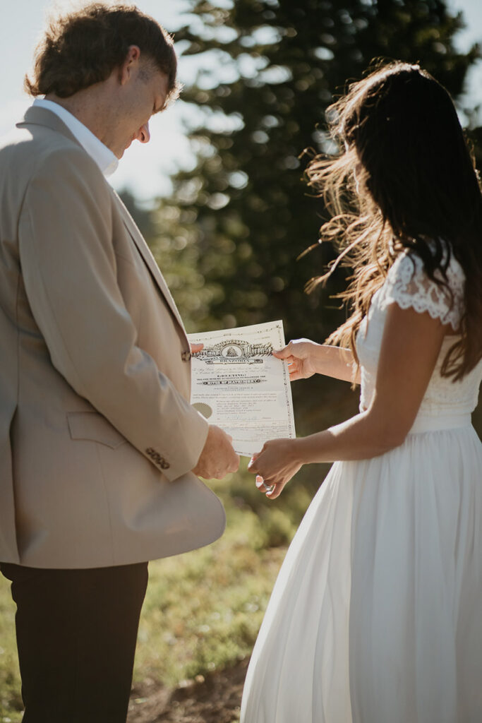 The couple looking at the wedding papers they signed. 