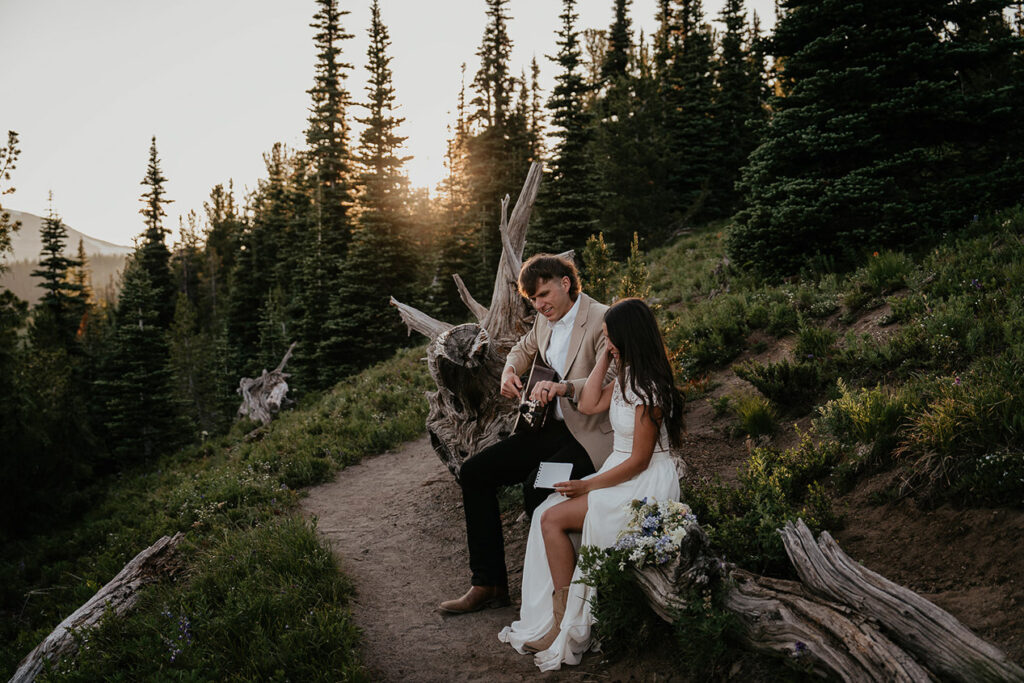 The husband playing guitar to his new wife. 