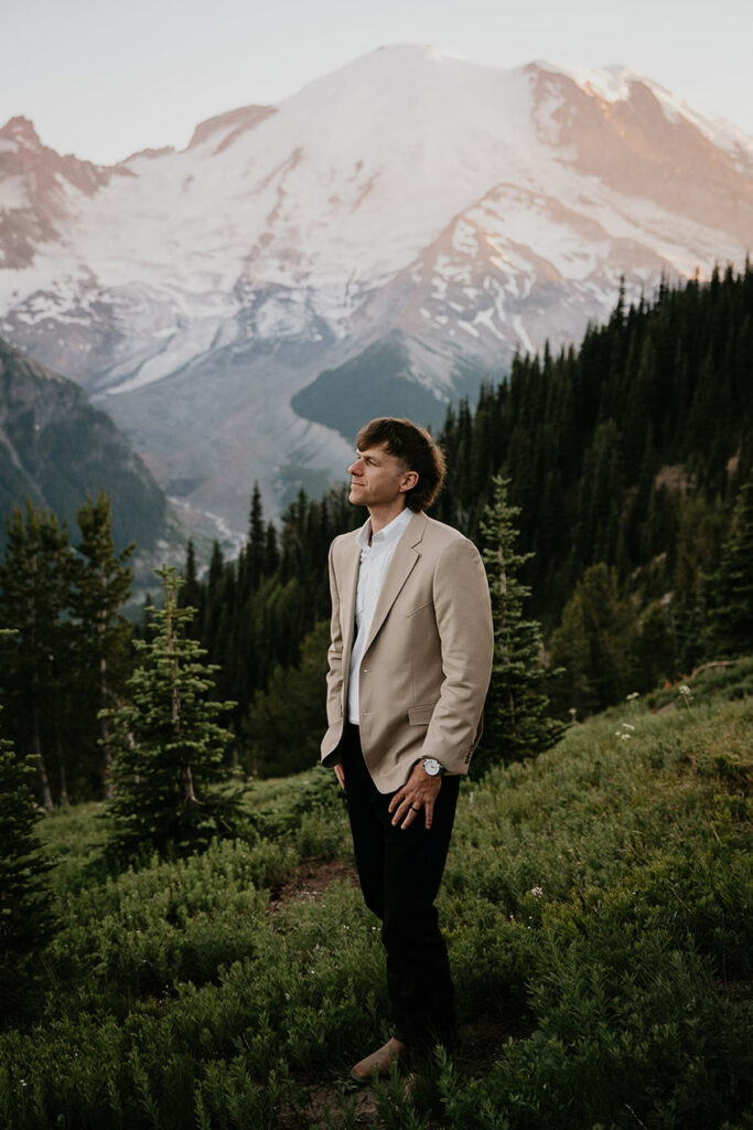 The husband posing with Mt Rainier in the background. 