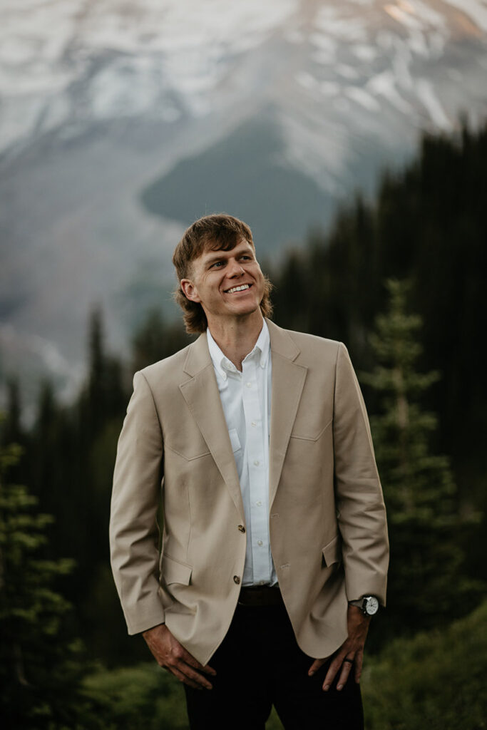 The husband posing with Mt Rainier in the background. 