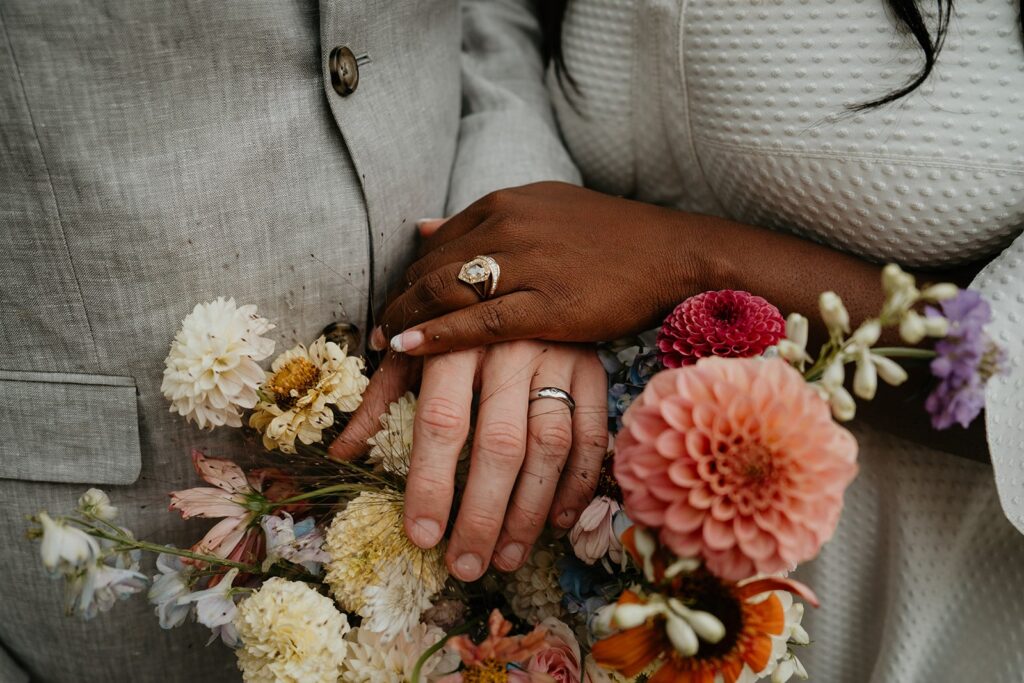 Bride and groom hold hands during Washington winery wedding couple photos