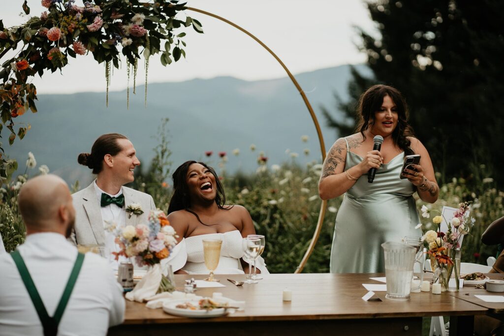 Main of Honor gives a speech during outdoor wedding reception at Washington winery wedding