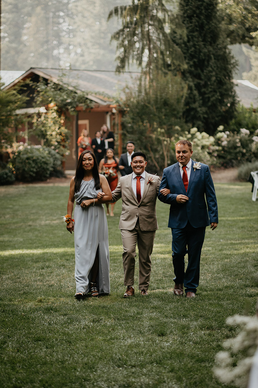 One of the brides walking down the isle with her parents at CedarVale Events. 