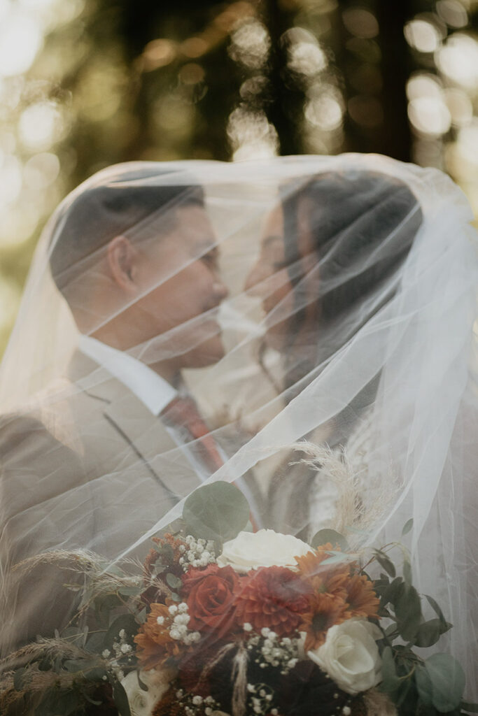 The brides close under a wedding dress vail. 