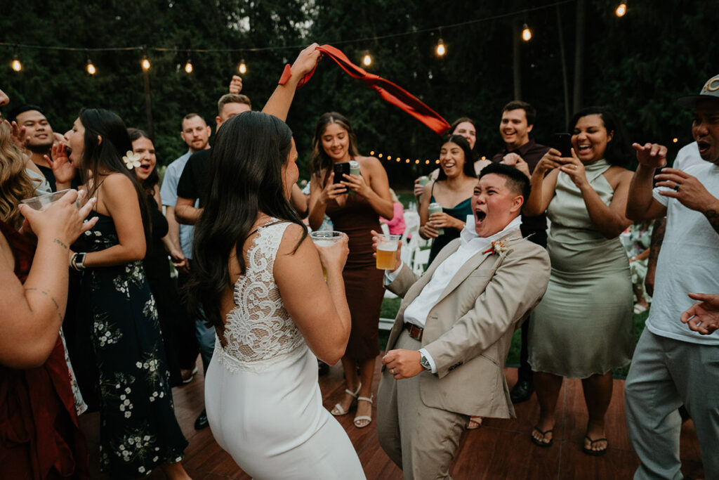 The wedding attendants and newlyweds dancing on the dance floor. 