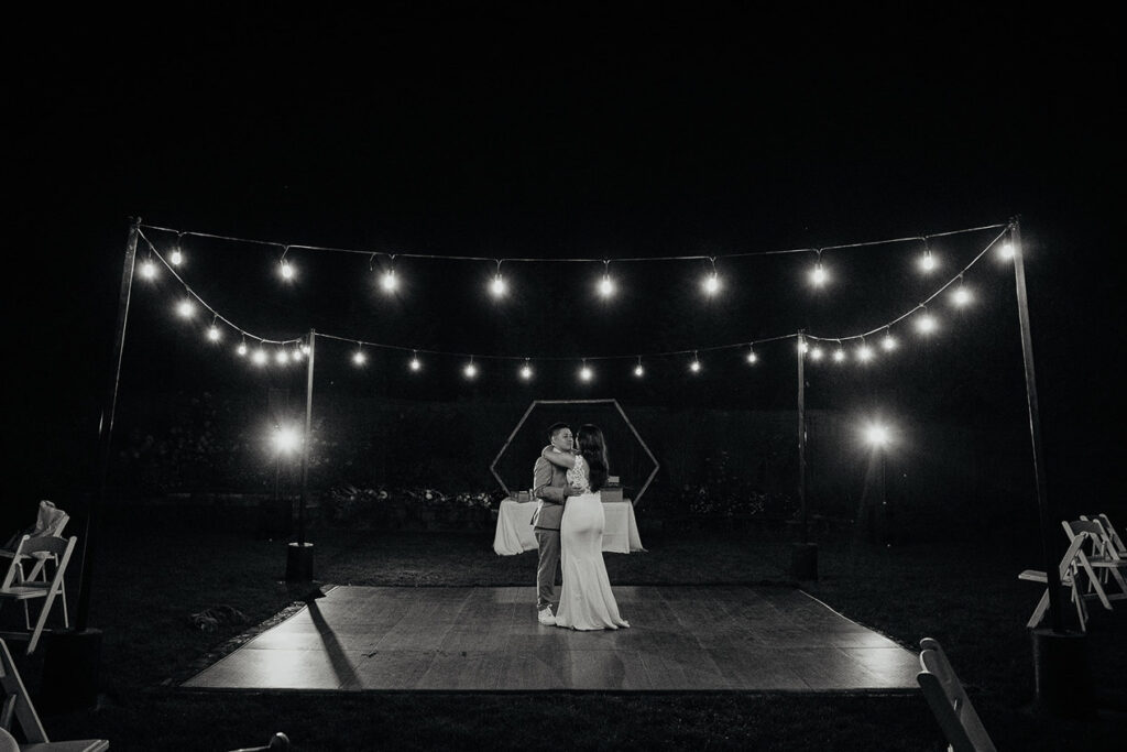 The newlyweds sharing an intimate dance by themselves under twinkly lights. 