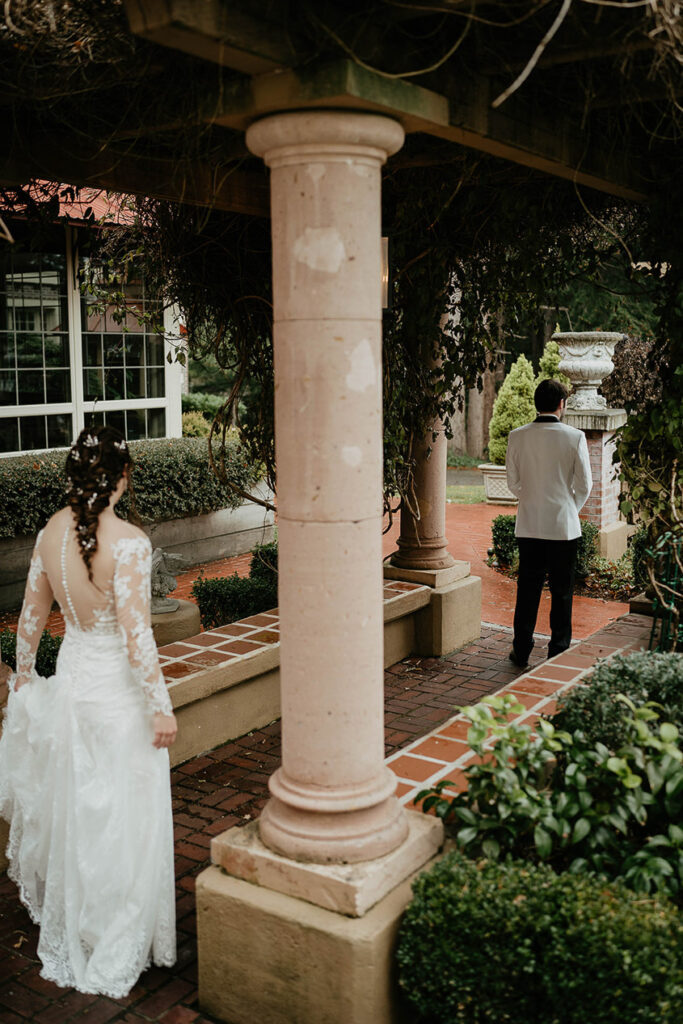 The bride heading toward the groom for a first look at Lairmont Manor. 