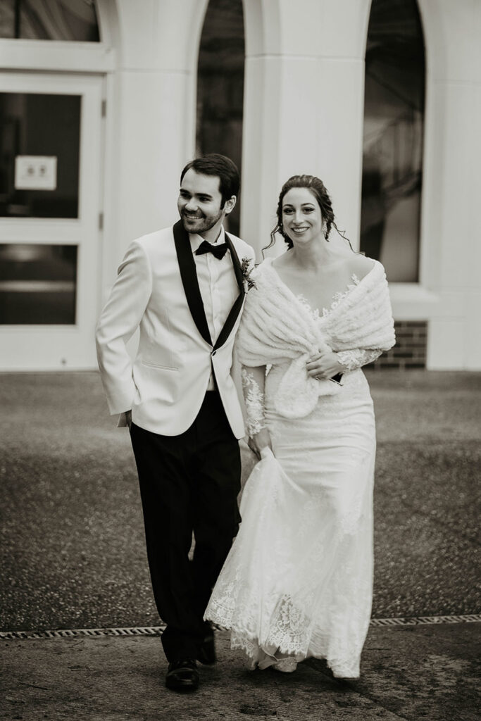 The bride and groom walking on the street. 