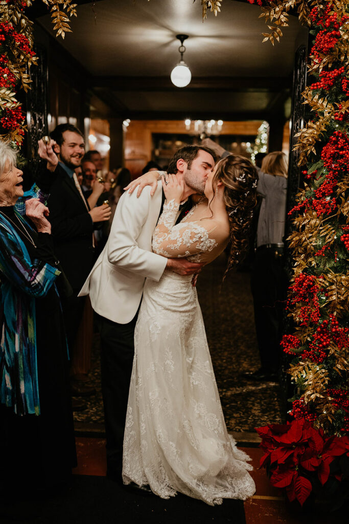 The bride and groom have a final kiss before leaving during their grand exit. 