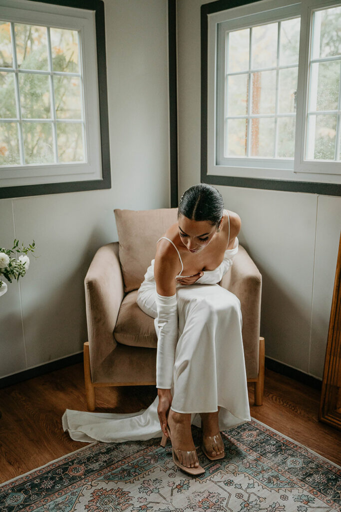 The bride getting ready and adjusting her heels. 