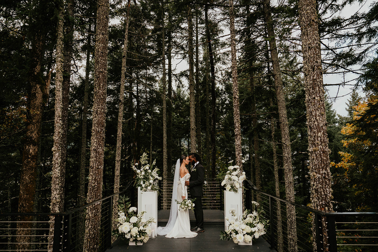 The bride and groom embracing each other at the alter.