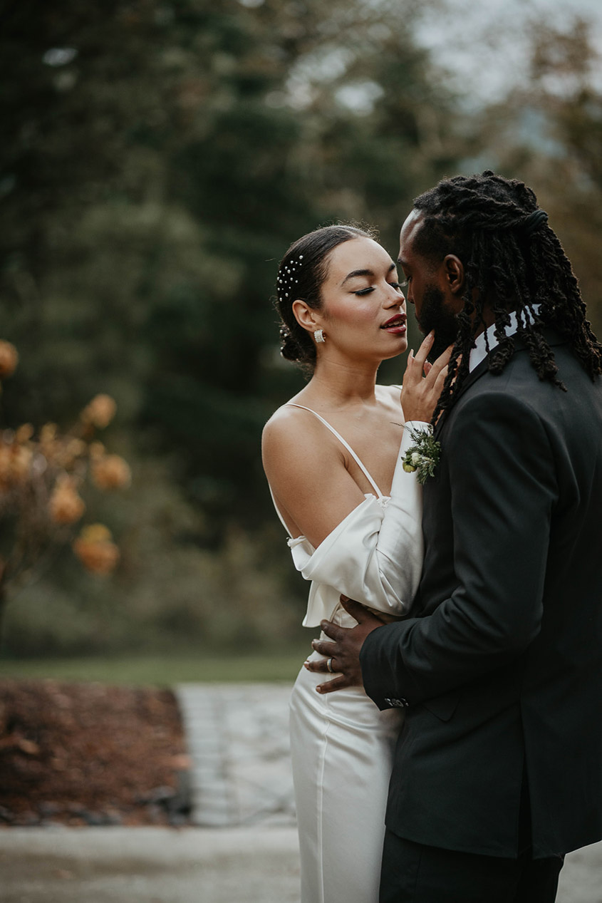 The bride and groom holding each other about to kiss. 