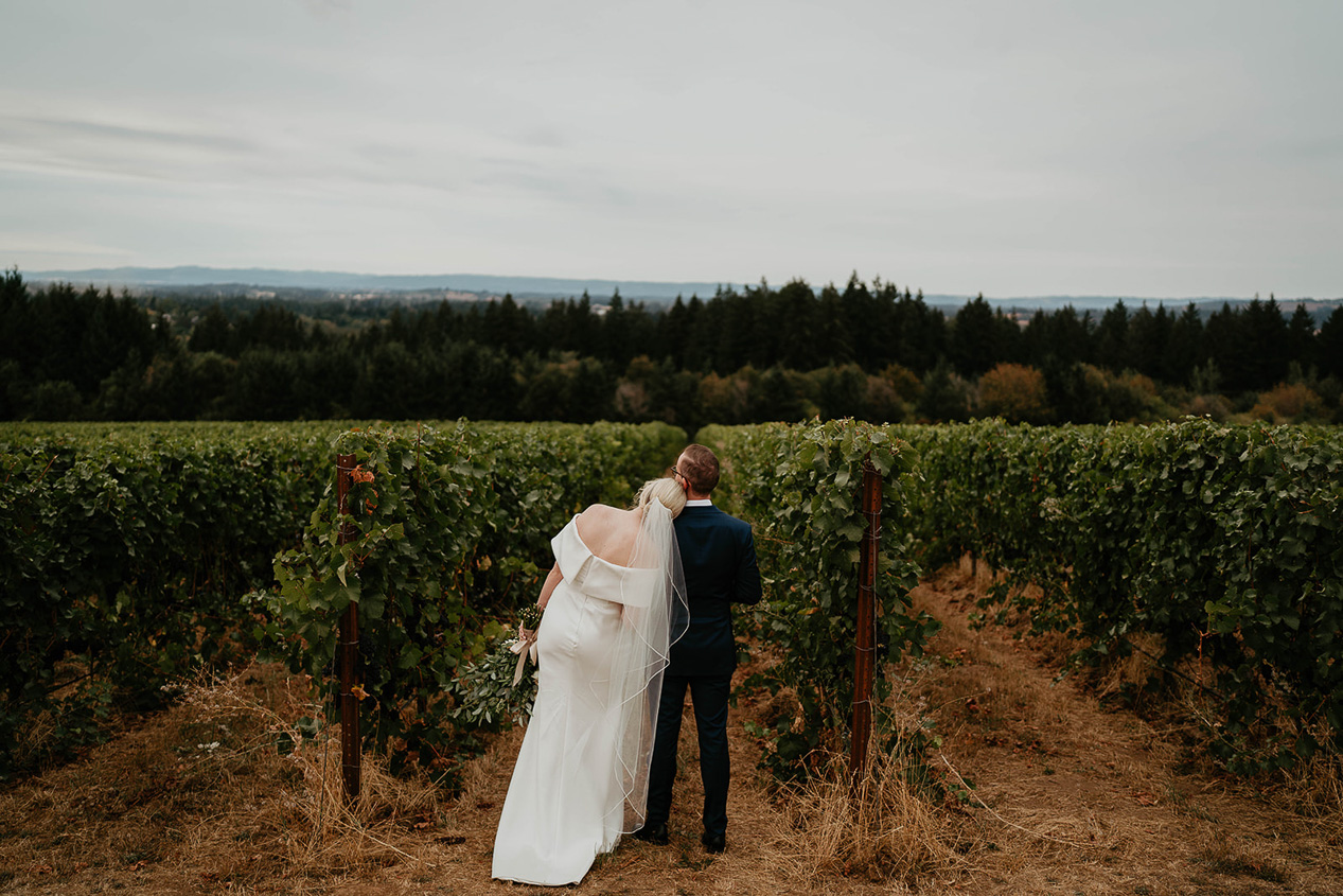 the bride resting her head on the room looking out at the views at Ponzi Vineyards, one of the best wedding venues in Oregon. 