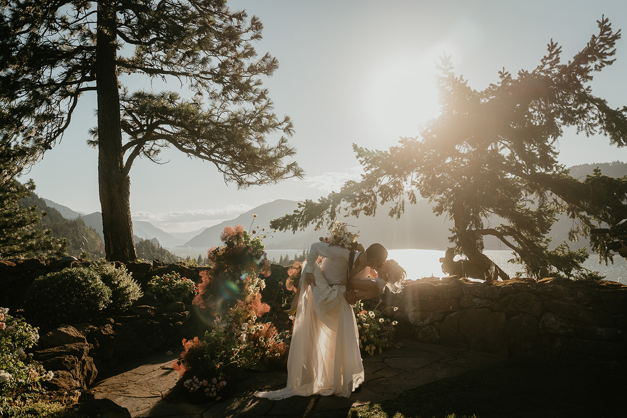 newlyweds kissing on a terrace at The Griffin House.