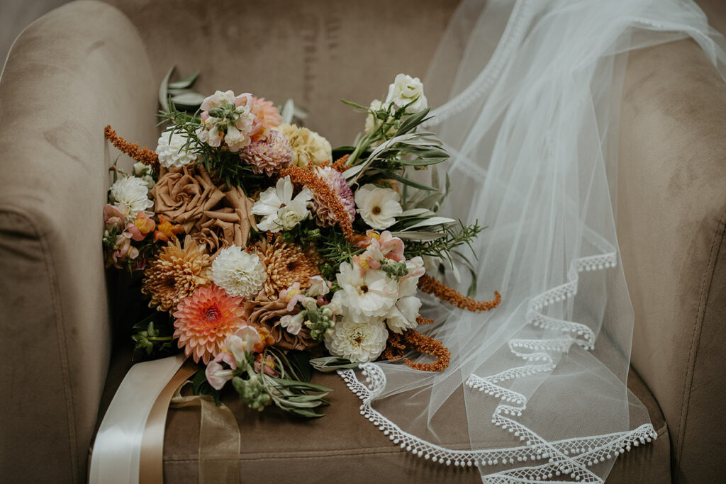 a bouquet of flowers sitting on a chair. 