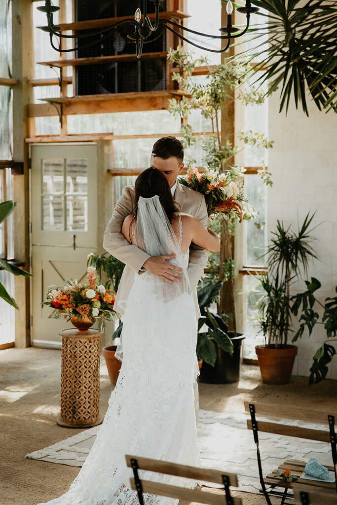 The bride and groom kissing after first looks inside Mt Hood Center. 