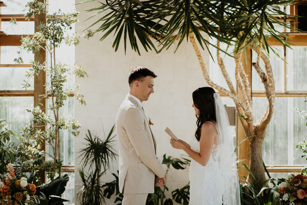 the bride and groom sharing their vows inside Mt Hood Center. 