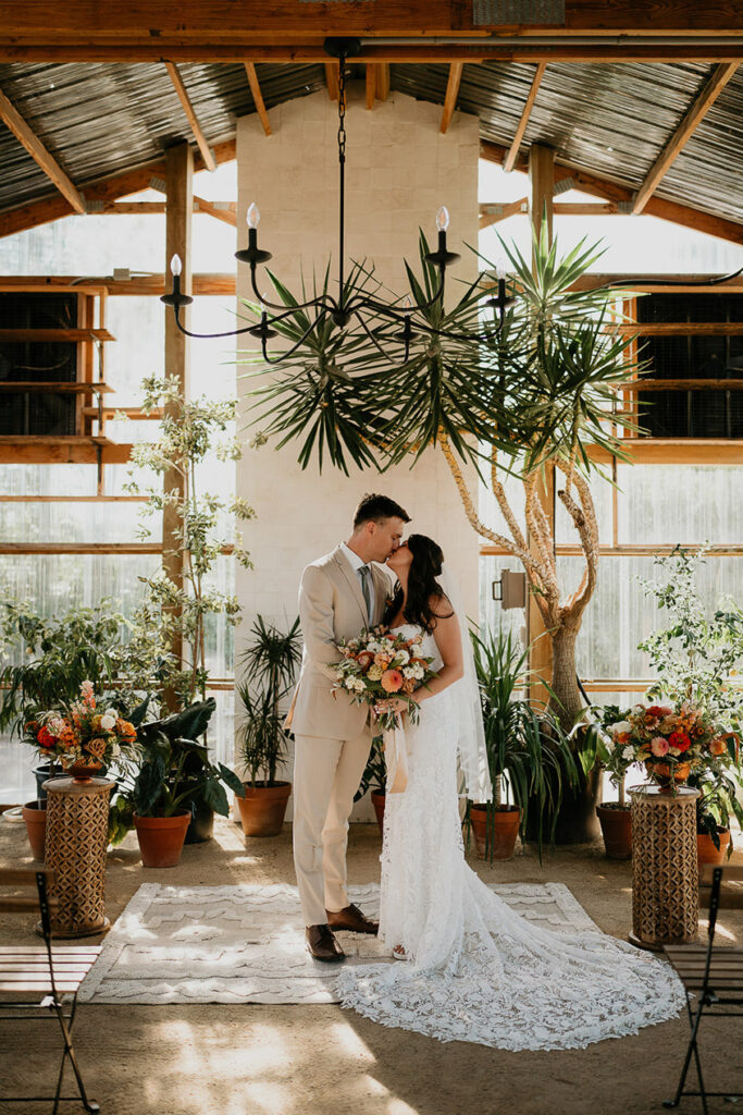 the bride and groom kissing inside Mt Hood Center. 