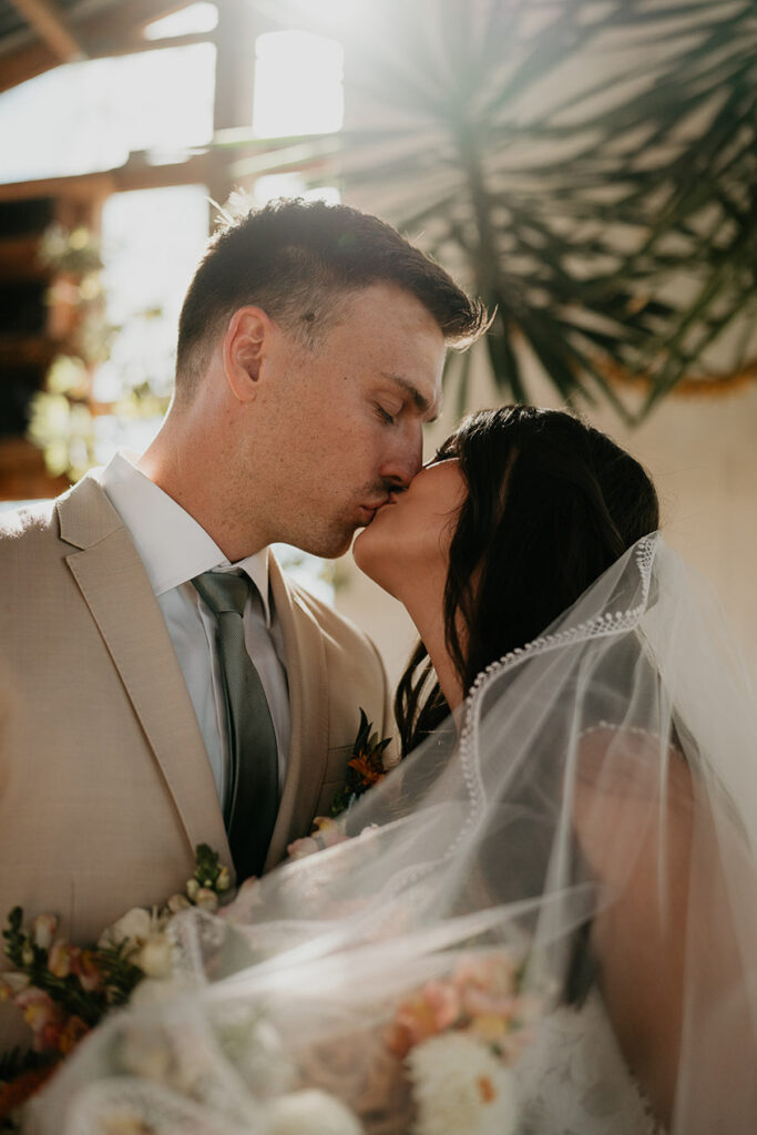 the bride and groom kissing inside Mt Hood Center. 