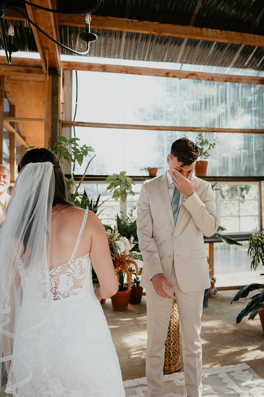 the groom tearing up from looking at the bride. 