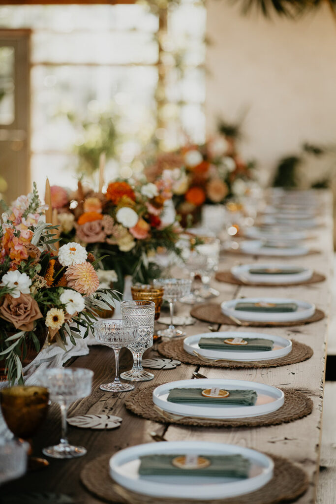 wedding reception details, including plates, cutlery, glasses, and table settings. 