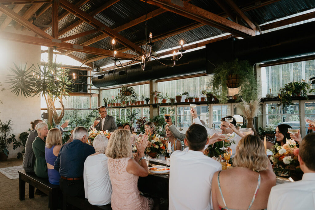 people cheersing at the wedding reception. 