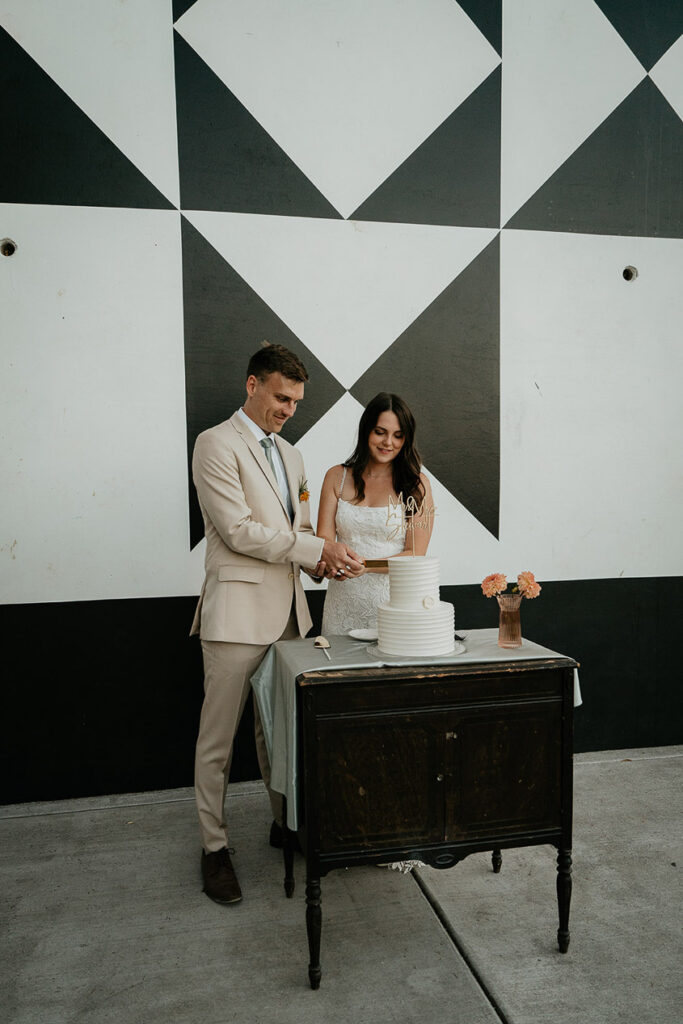 newlyweds cutting their wedding cake. 