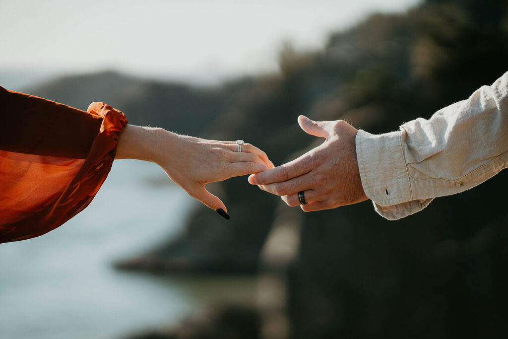 a close up of the husband and wife's hands, and their rings. 