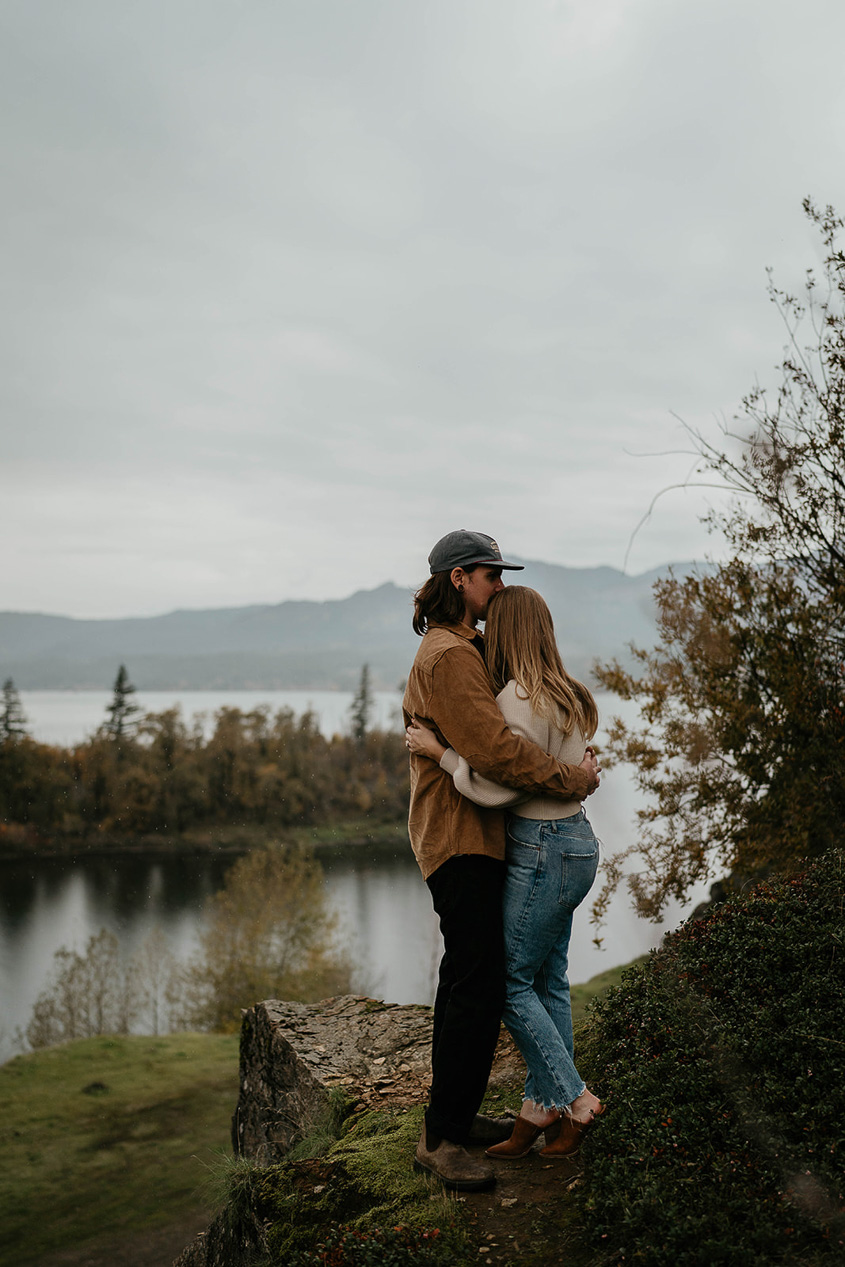 A newly engaged couple with the Columbia River Gorge in the background. 