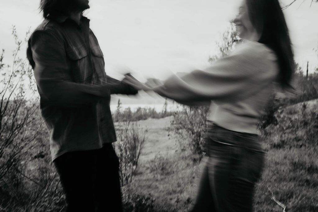 a newly engaged couple dancing in nature. 