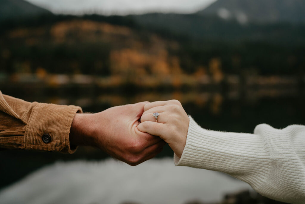 A newly engaged couple's hands, with a ring on the future bride's finger. 