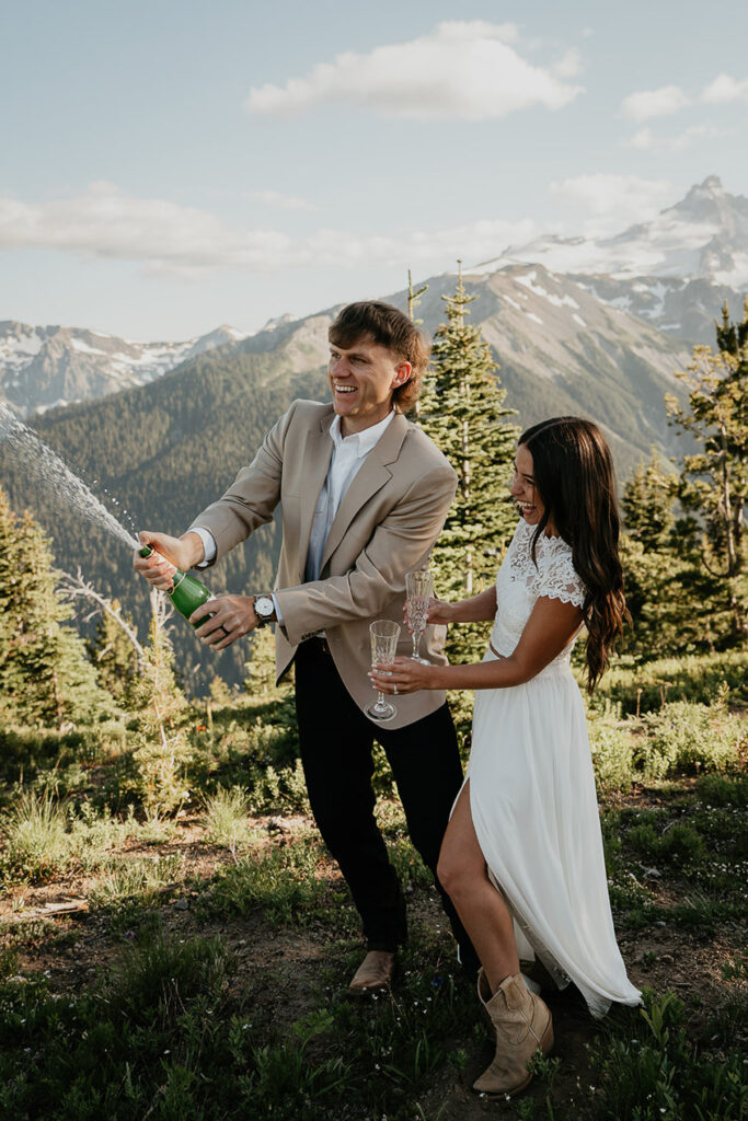 A newlywed couple spraying champagne after getting married. 