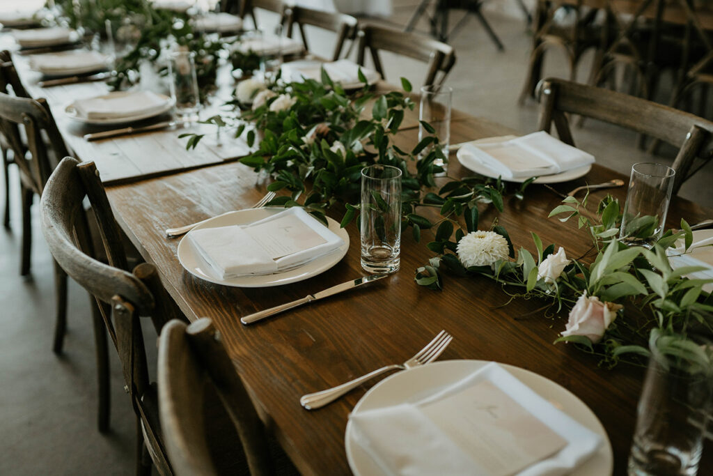 The Orchard Hood River table settings with branches and flowers. 