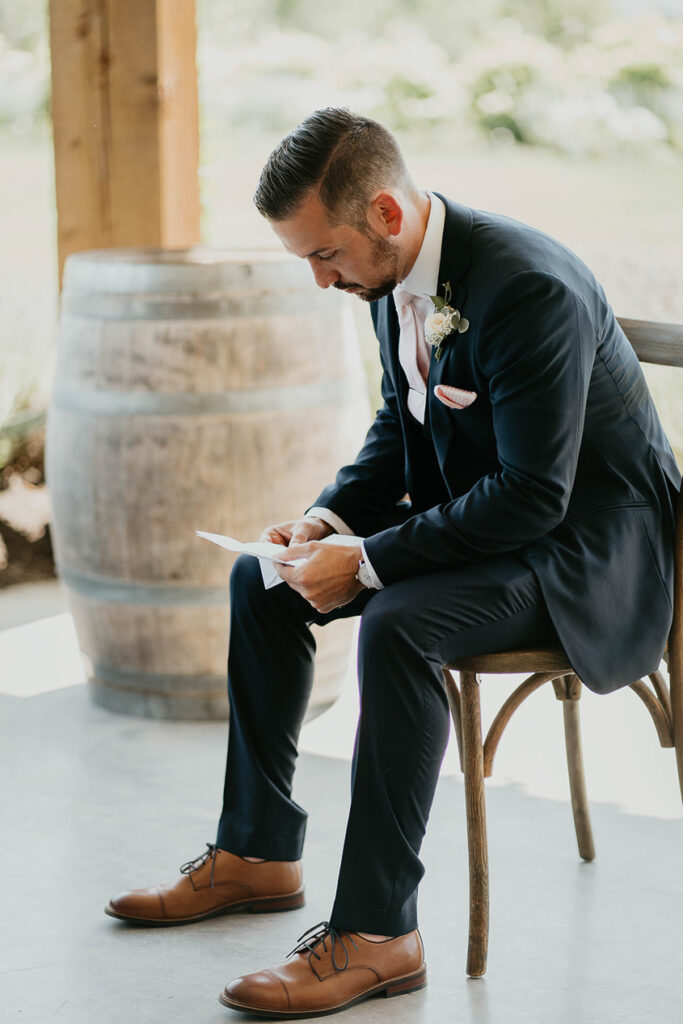 The groom reading his vows. 