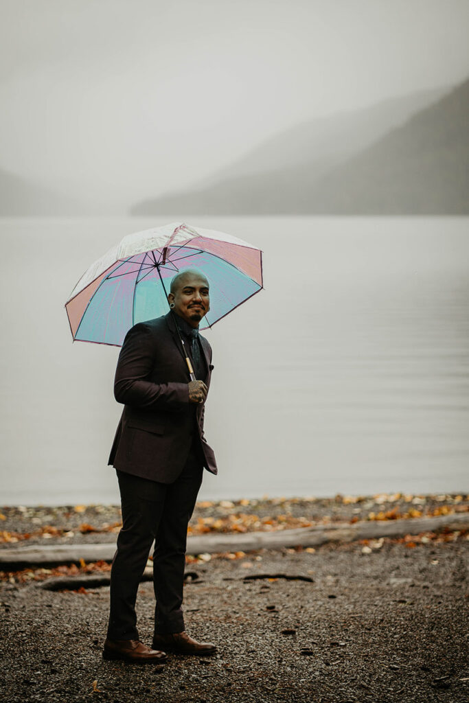 The groom smiling with Lake Crescent in the background. 