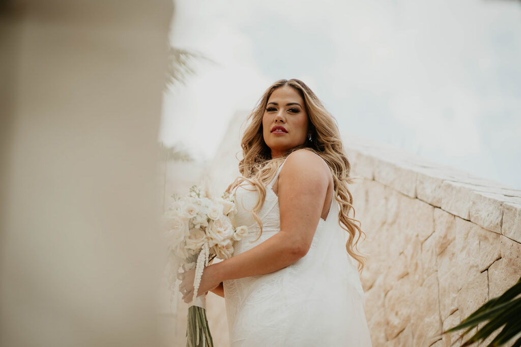 the bride posing on a set of stairs during their Mexico destination wedding. 