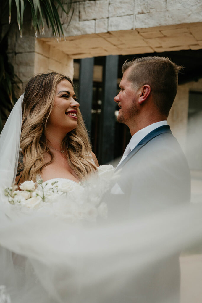 The bride and groom looking lovingly into each other's eyes. 