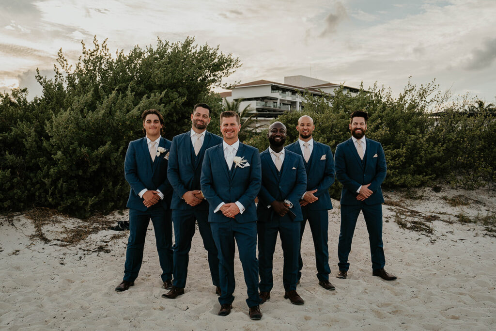 the groomsmen behind the groom. 