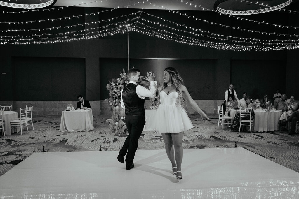 The bride and groom dancing under twinkling lights at their Mexico destination wedding. 