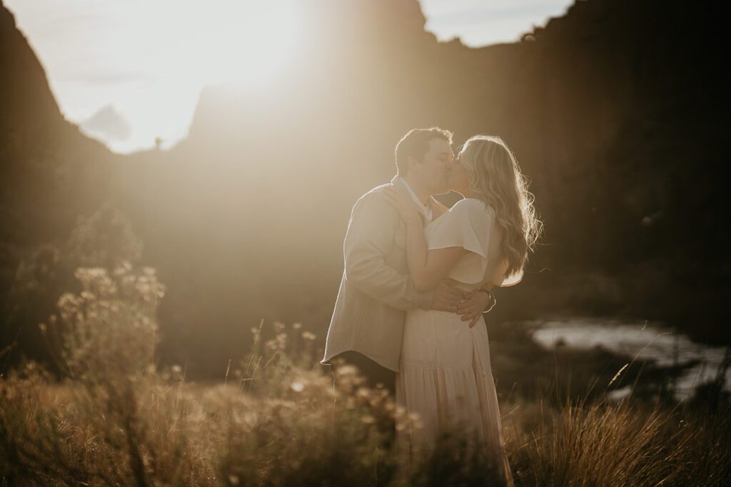 a couple kissing at sunset during their Smith Rock engagement session. 